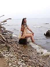 A lovely older woman is posing nude