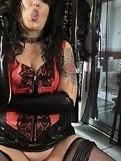 The mistress is smoking a cigar through a sex toy