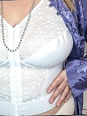 Hot mature brunette shows off her pantyhose clad pussy by lifting her skirt